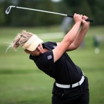 Brooke Henderson practices golf at the driving range
