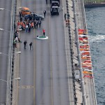 Tiger Woods in Turkey hitting a golf ball on the Bosphorus Bridge, which connects Europe and Asia